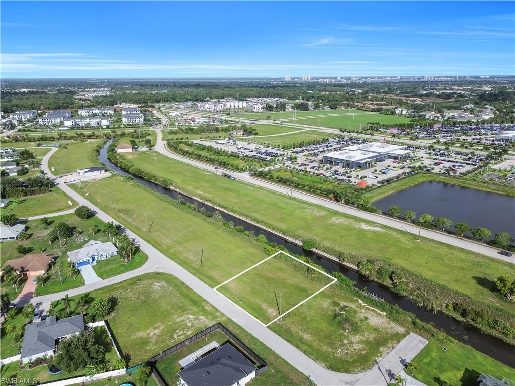 Unimproved land parcel featuring a grassed surface and surrounding residential properties