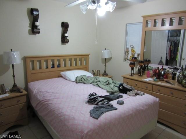 Neutral wall paint, tile flooring, and a ceiling fan with integrated lighting