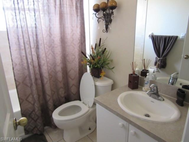Bathroom featuring a white vanity with an integrated sink, laminate countertop, and chrome faucet