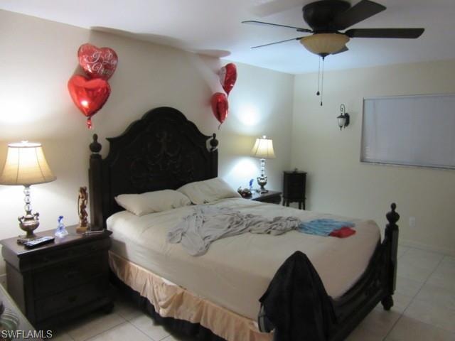 Room featuring light-toned walls and square tile flooring