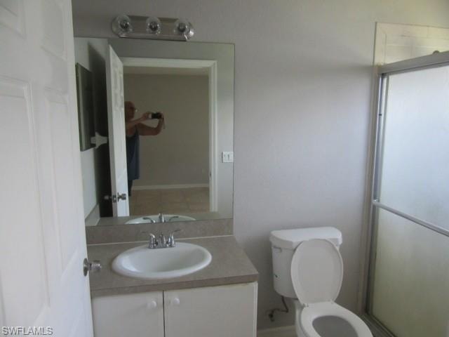 Vanity with an integrated sink, polished chrome faucet, and expansive wall-mounted mirror