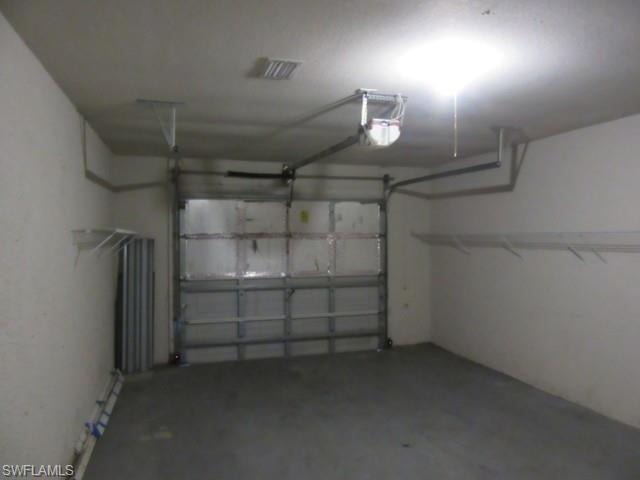 Spacious garage with a concrete floor and neutral-toned walls