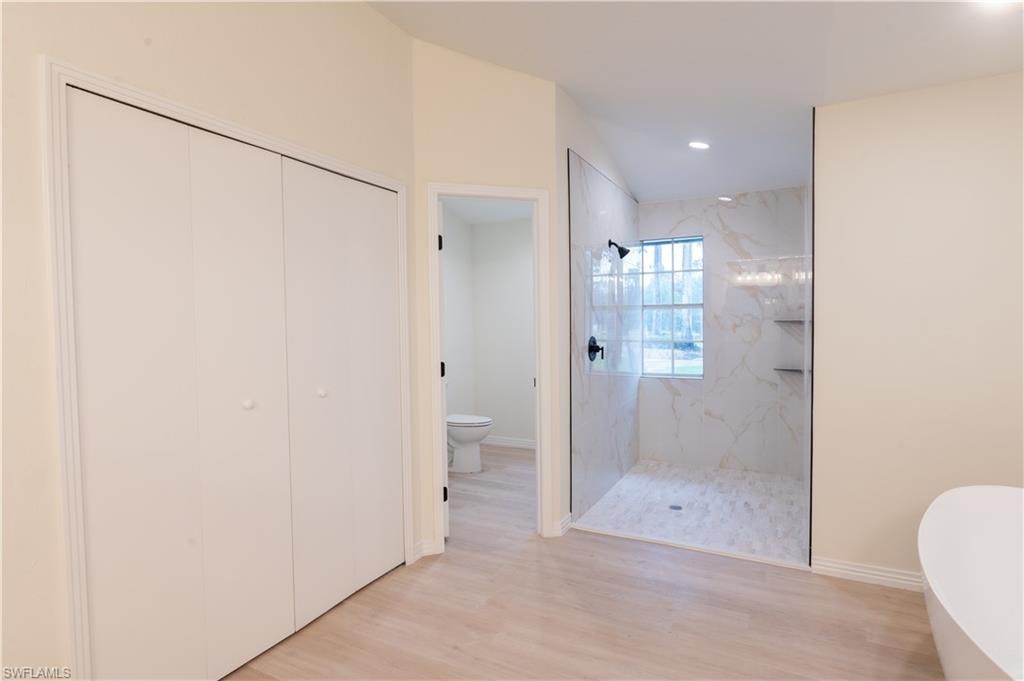 Neutral wall tones, wood-finish flooring, and crown molding define this room