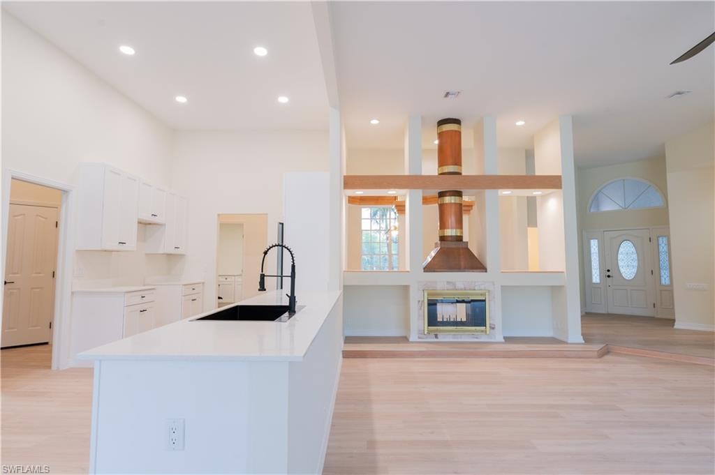 Expansive living area with high ceilings and wood-finish flooring