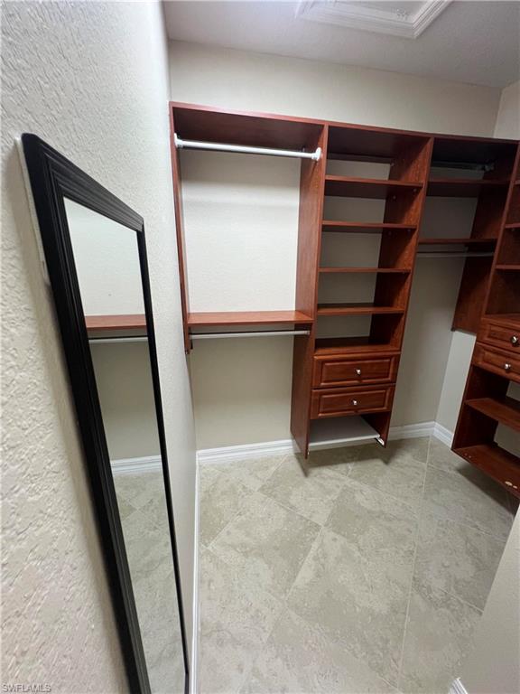 Walk in closet with tile floors