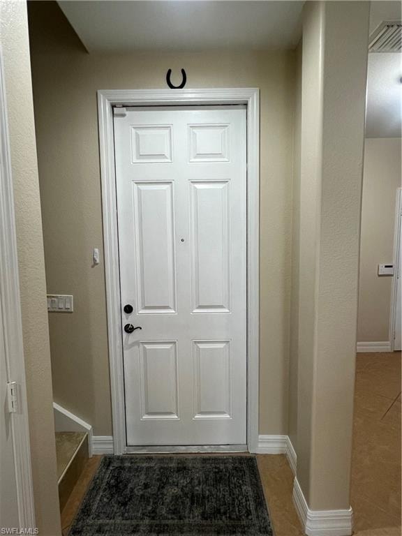 Doorway to outside with tile flooring