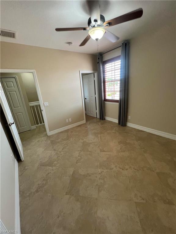 Unfurnished bedroom featuring tile flooring and ceiling fan