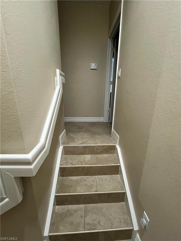 Staircase featuring tile floors