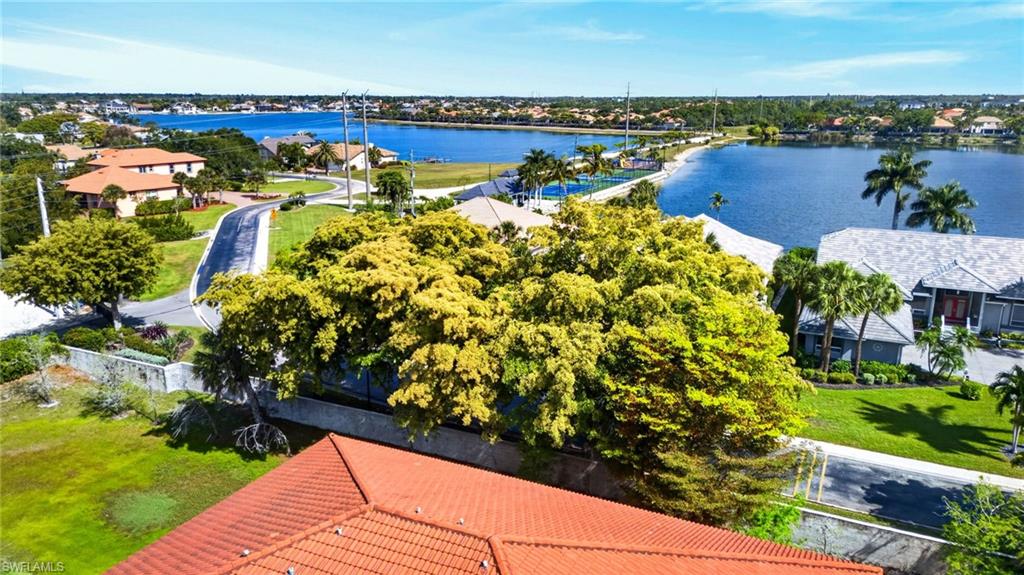Aerial perspective showcasing expansive water frontage with surrounding residential properties