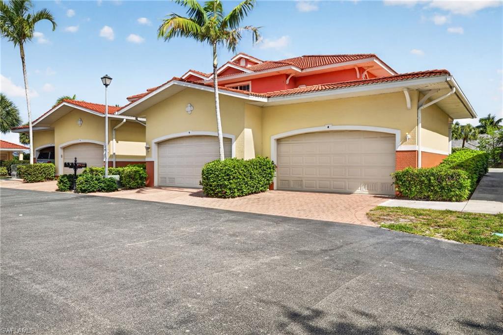 Mediterranean-inspired exterior with terracotta tile roofing and painted stucco