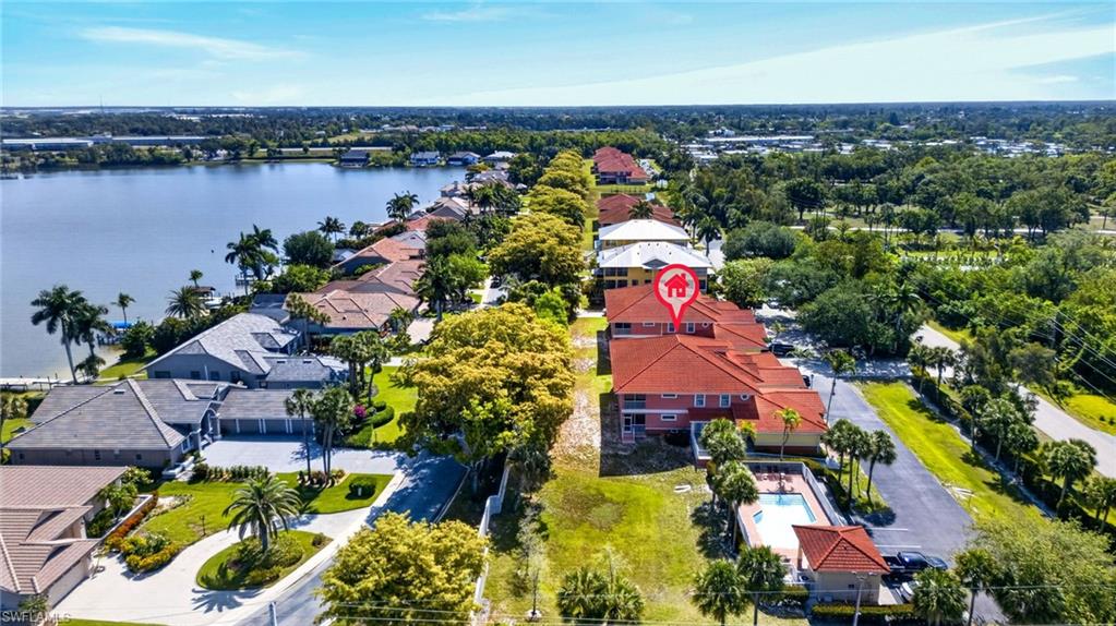 Aerial perspective showcasing waterfront properties along a sizable body of water
