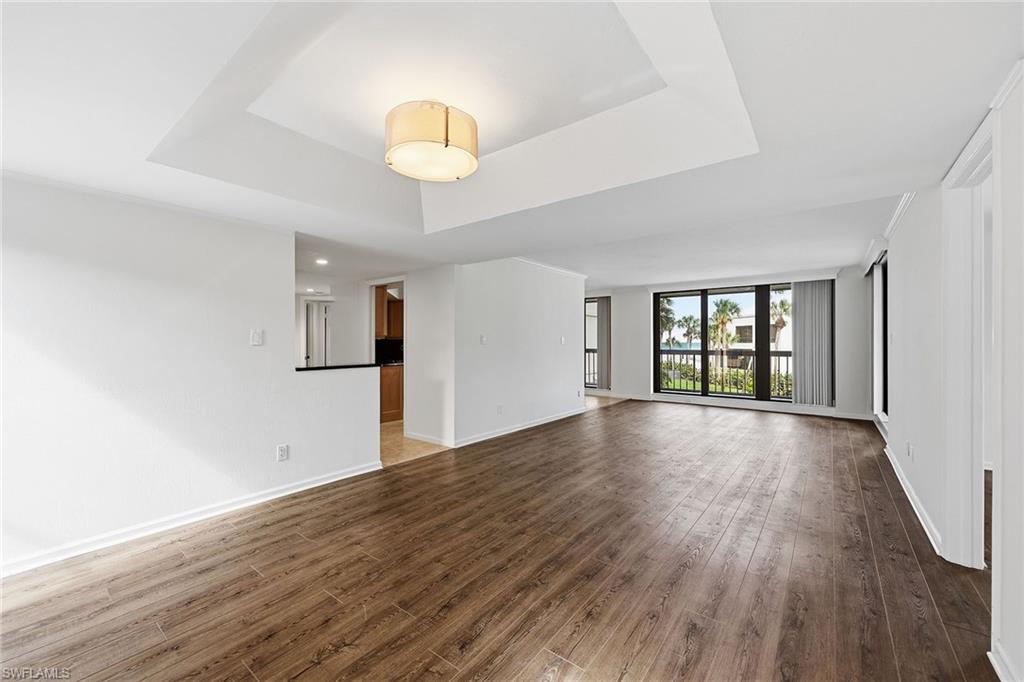 Long view of Living Room with wood floor. out to balcony.