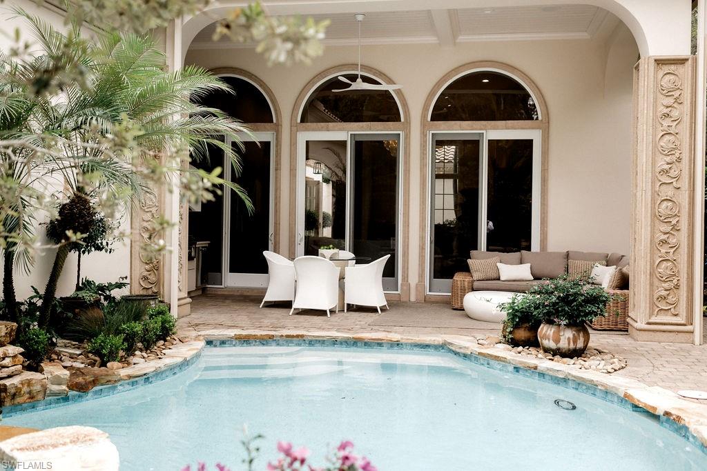 Outdoor patio featuring a built-in swimming pool with tile trim and stone coping
