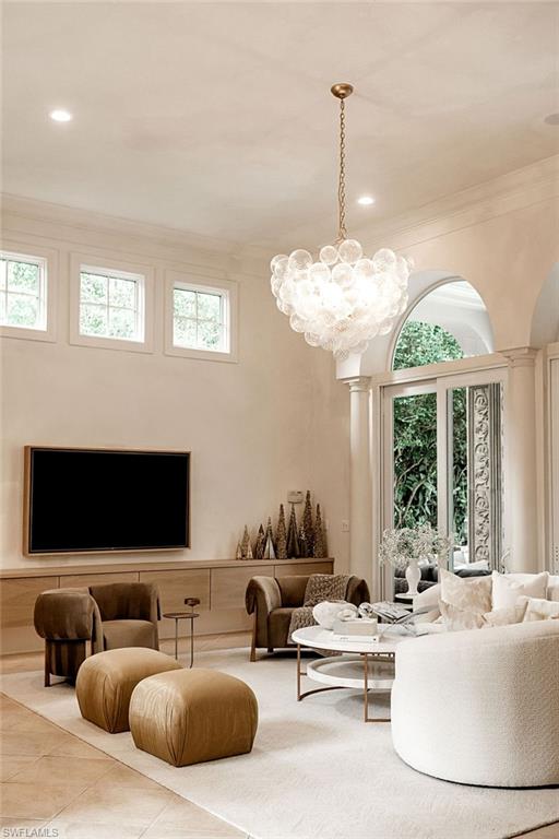 Light-filled living area featuring a multi-tiered bubble chandelier, recessed lighting, and a neutral color palette