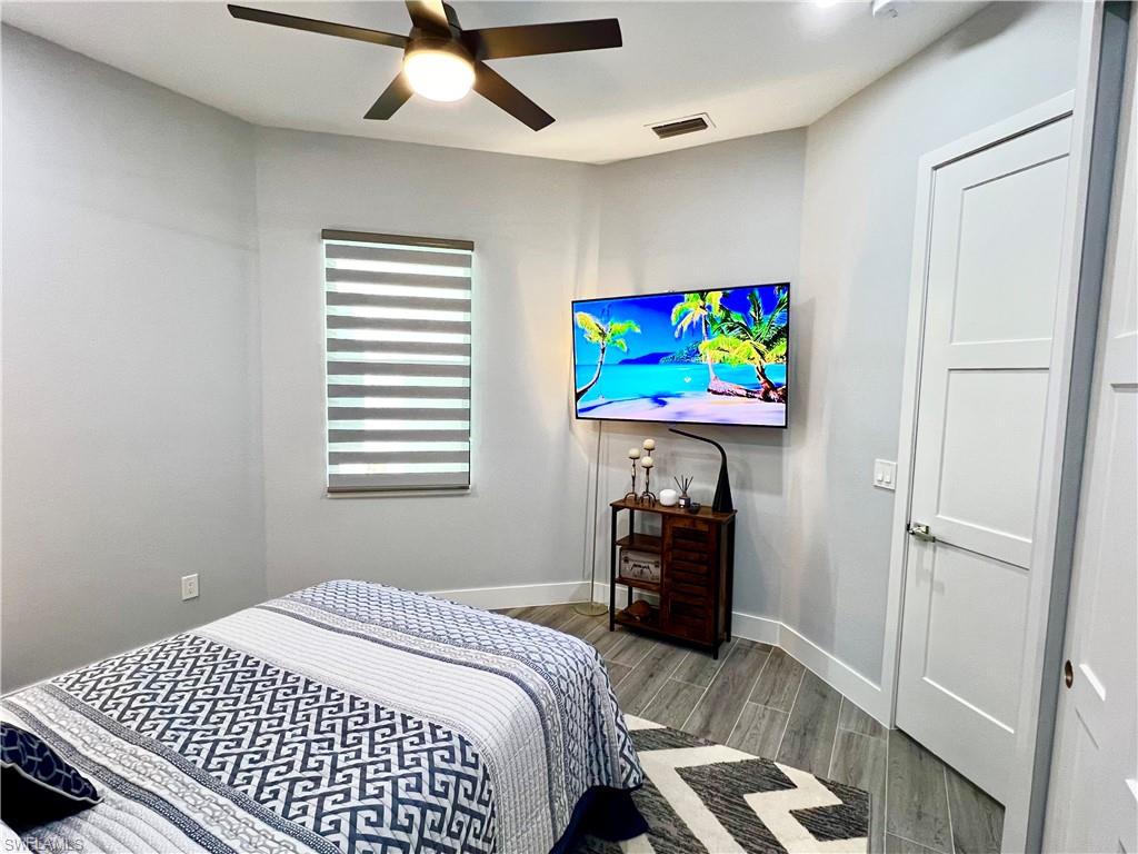 Light gray wall finishes with wood-finish flooring