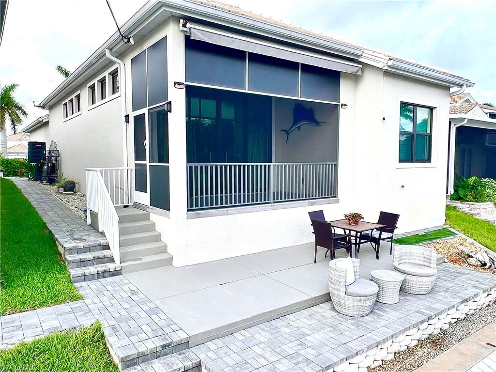 Exterior patio featuring a concrete slab and paver hardscaping
