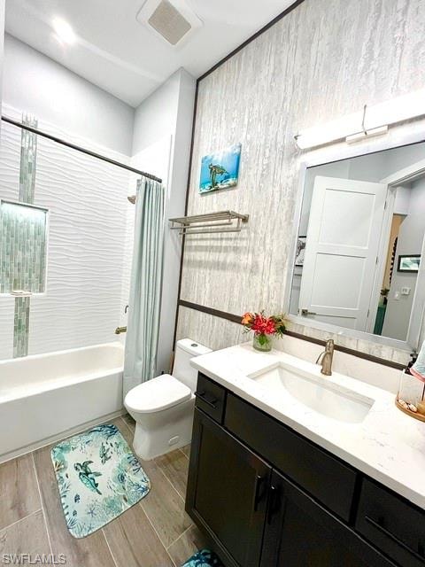 Bathroom featuring a dark wood-finish vanity with a white countertop and integrated sink, a brushed nickel faucet, and a wall-mounted mirror
