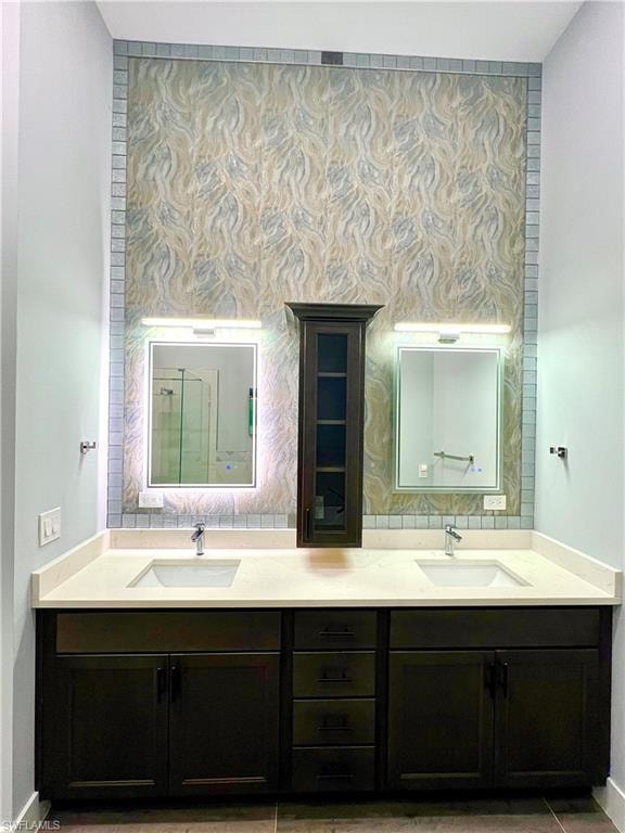 Dual vanity with dark wood-finish cabinetry, light-toned countertops, and undermount sinks