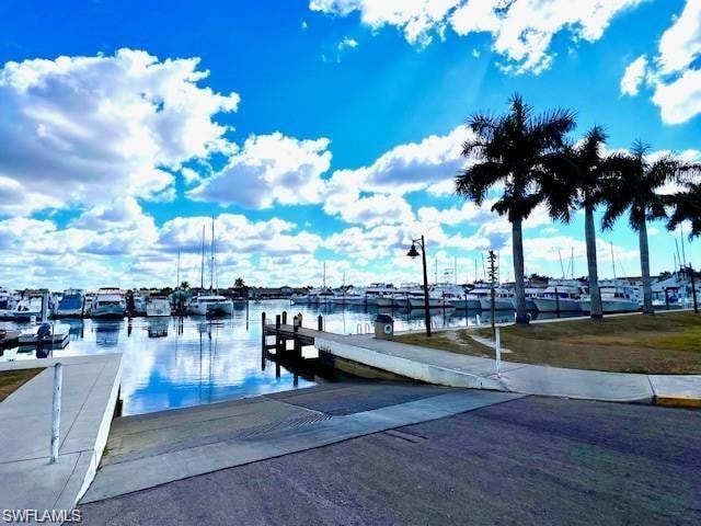 Paved boat launch with an adjacent pier and marina