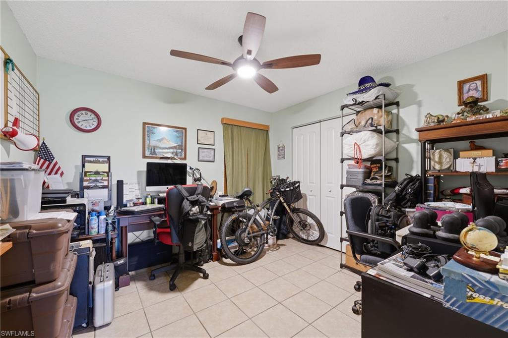 Room featuring tile flooring and a ceiling fan with integrated lighting