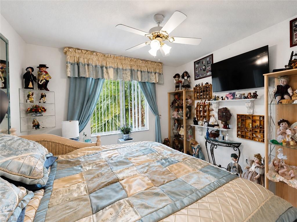 Spacious room featuring a ceiling fan with integrated lighting, window with vertical blinds, and ample wall space