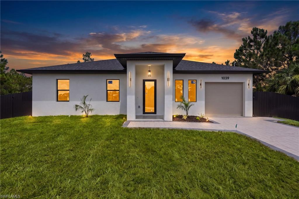 Contemporary single-story residence featuring a smooth stucco exterior with a contrasting dark roofline. This is a rendering image
