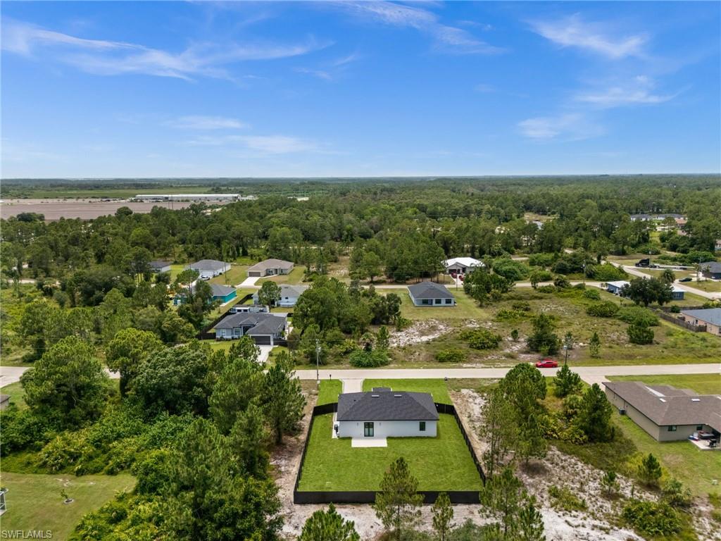 Contemporary single-story home featuring a dark shingle roof and a light-colored exterior