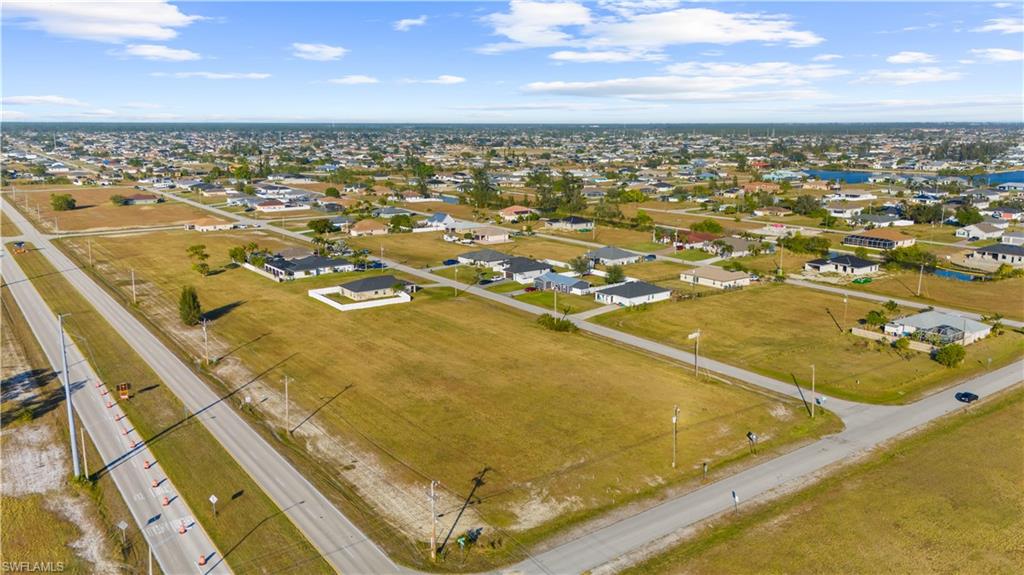 Expansive aerial view showcasing multiple vacant land parcels alongside existing residential properties