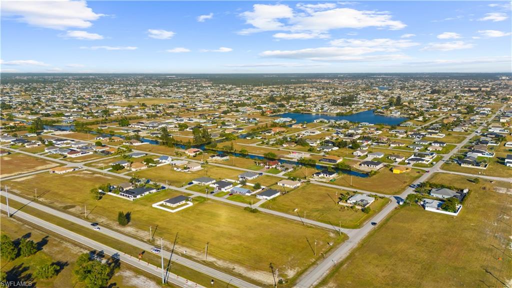 Aerial perspective showcasing a residential area with multiple properties and undeveloped lots