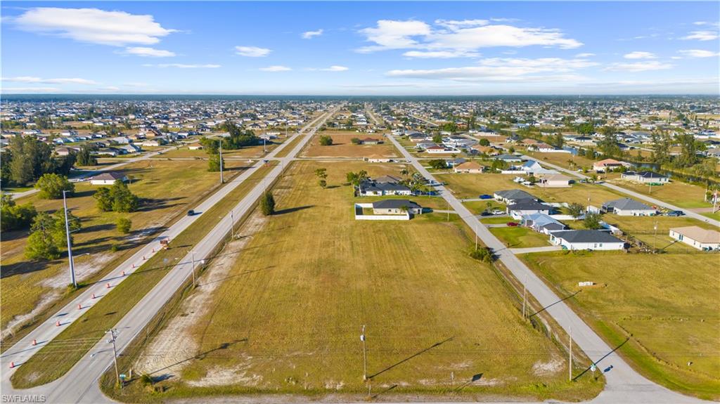 Expansive aerial perspective showcasing a grid of residential streets and numerous single-story homes