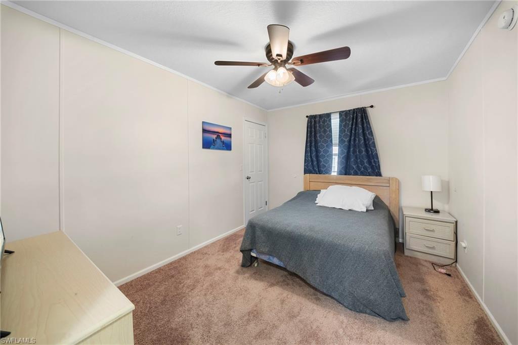 Neutral-toned walls complement the brown carpeted flooring