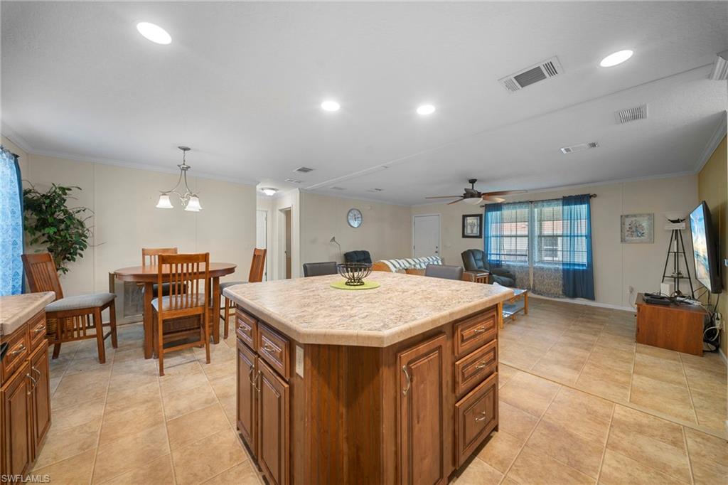 Kitchen island with tile-finish countertop and wood cabinetry