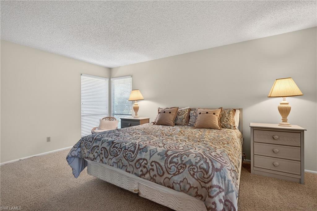 Primary bedroom with a textured ceiling