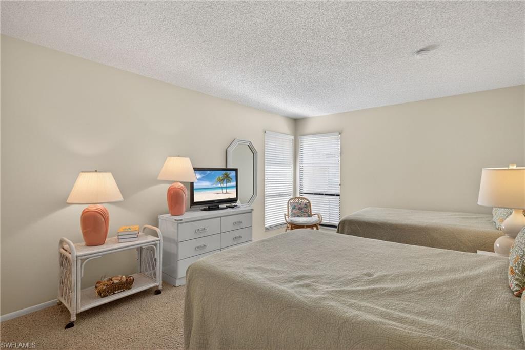 Bedroom with carpet flooring and a textured ceiling