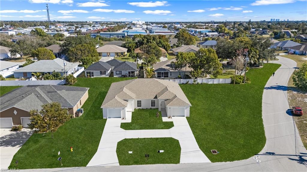 Duplex property featuring two separate residences, each with an attached garage and individual driveway