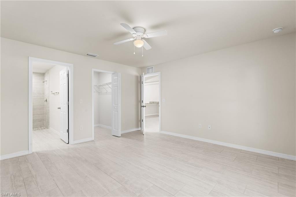 Spacious room featuring wood-finish flooring and neutral wall tones