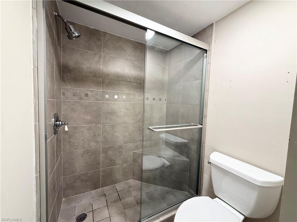 Tiled step in shower with corner seat.