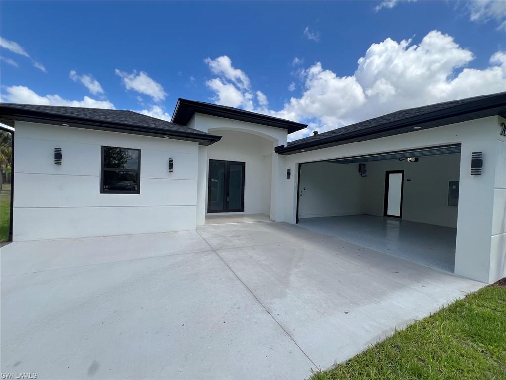 Contemporary exterior with a white stucco finish and dark trim accents