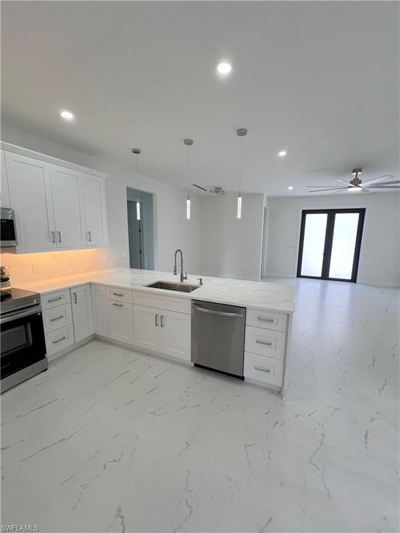 Modern kitchen with white cabinetry and light-toned countertops