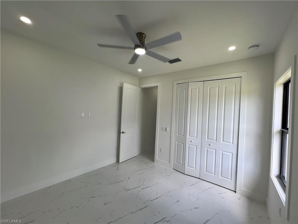 2nd bedroom room featuring white walls, recessed lighting, and a ceiling fan