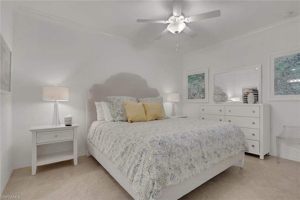 Bright room featuring light-toned flooring, crown molding, and a ceiling fan with integrated lighting
