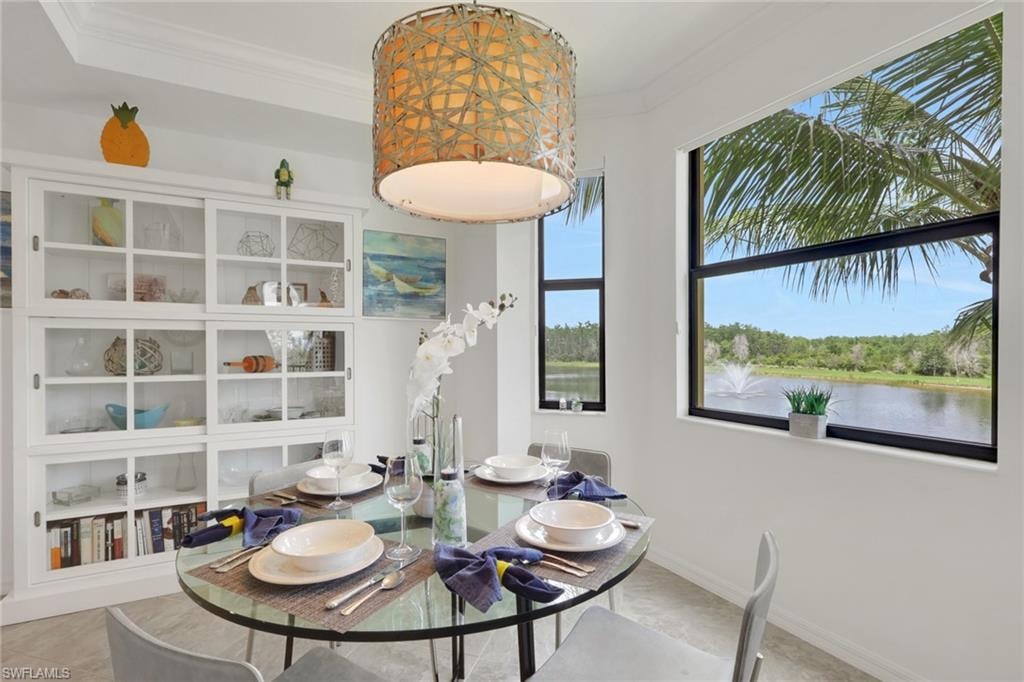 Dining area featuring a contemporary glass-top dining table, a woven drum pendant light fixture, and built-in white cabinetry with glass-front doors