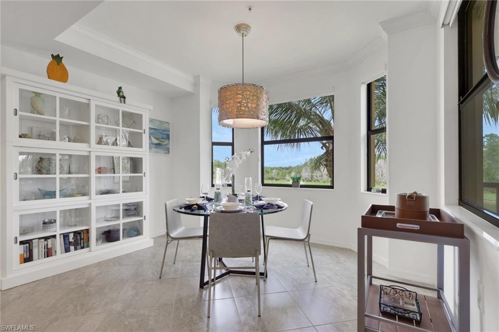 Dining area featuring a contemporary chandelier, multiple windows, and light-toned tile flooring