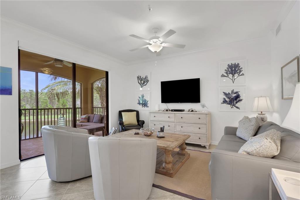 Living area with tile flooring and crown molding