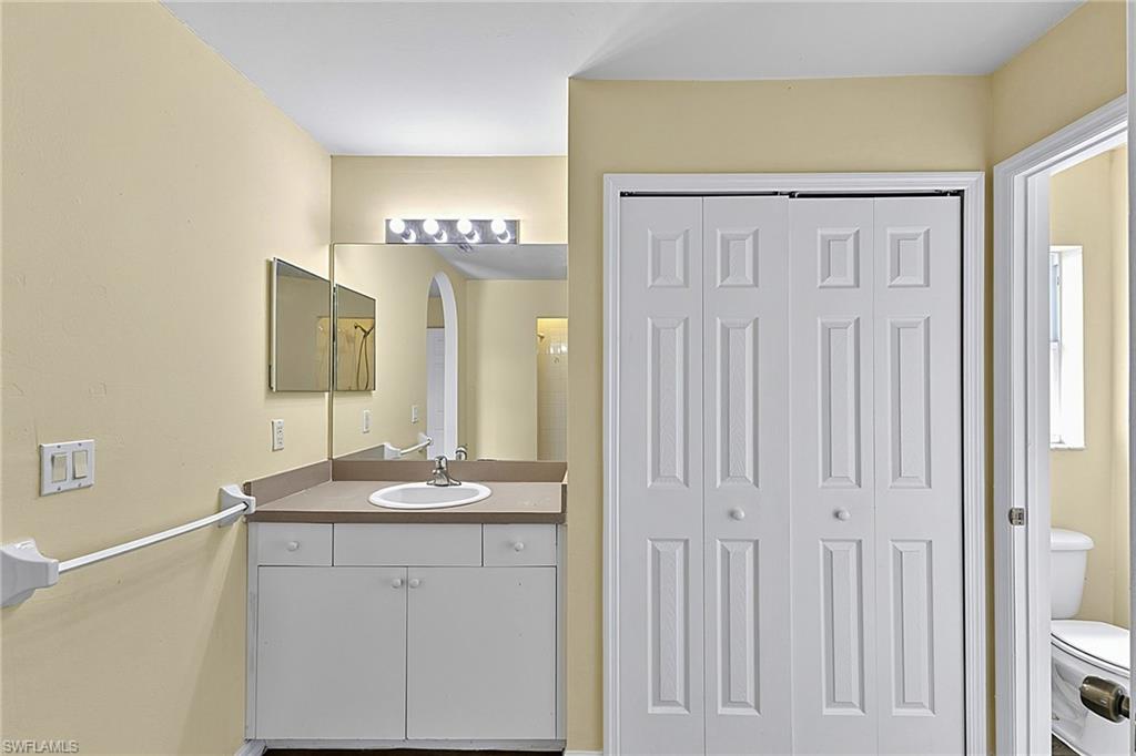 Bathroom vanity featuring a single sink, integrated countertop, and lower cabinetry