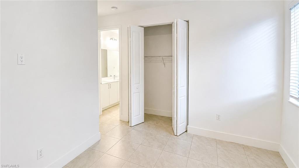 Room featuring tile flooring and white baseboards