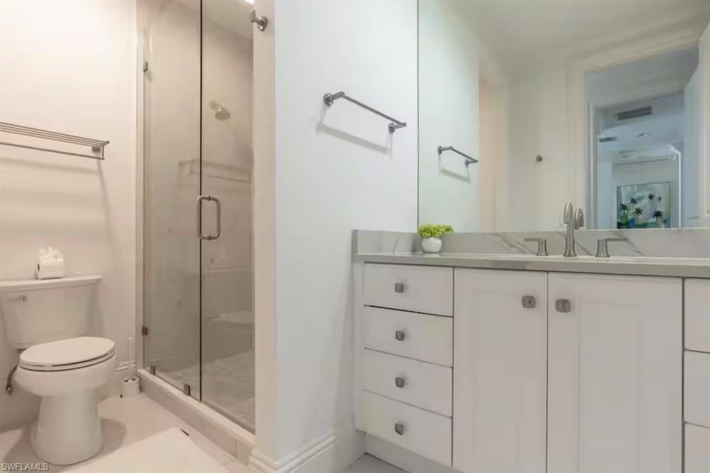 Full bathroom with vanity and a stall shower