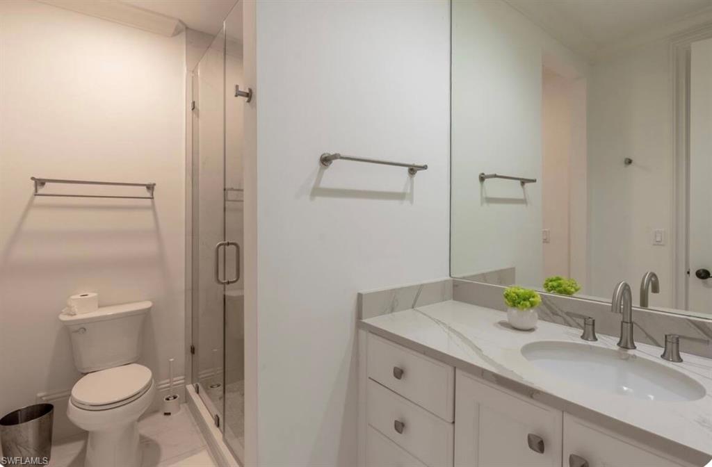 Full bathroom featuring vanity and a shower stall