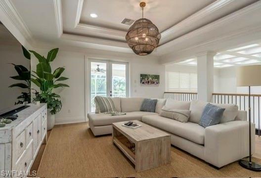 Living area with crown molding and a tray ceiling