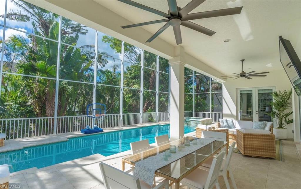 Integrated pool / spa featuring french doors, a patio area, glass enclosure, and outdoor lounge area